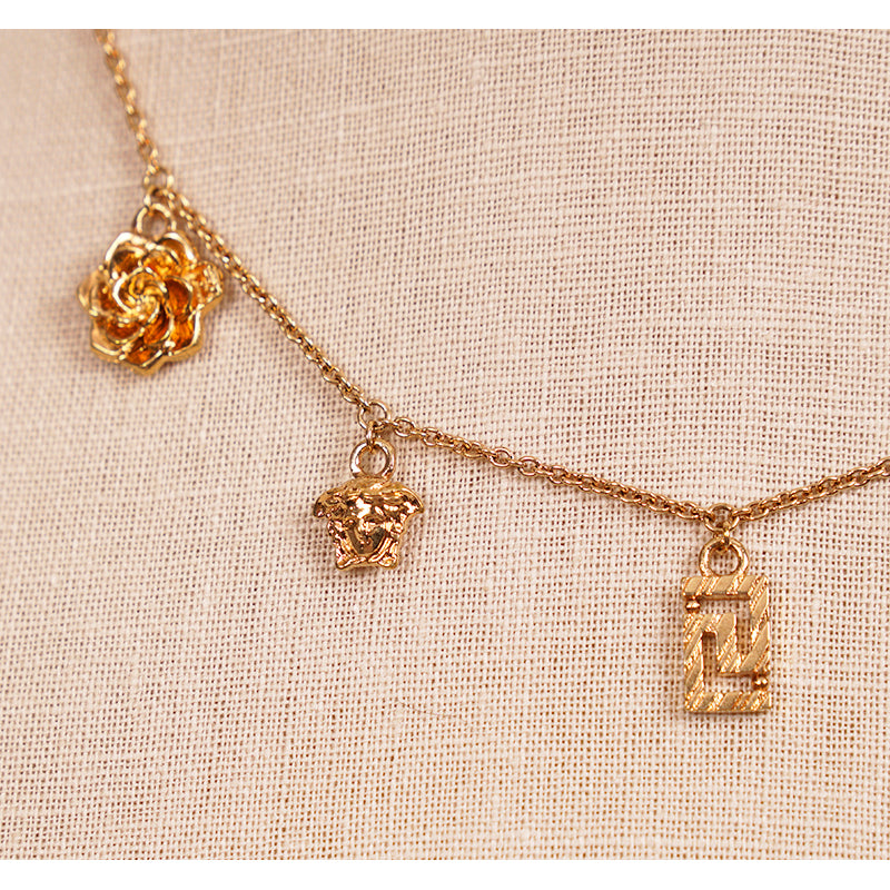 NEW $625 VERSACE Tribute Gold Brass MICRO CHARM Logo MEDUSA, GRECA & V NECKLACE